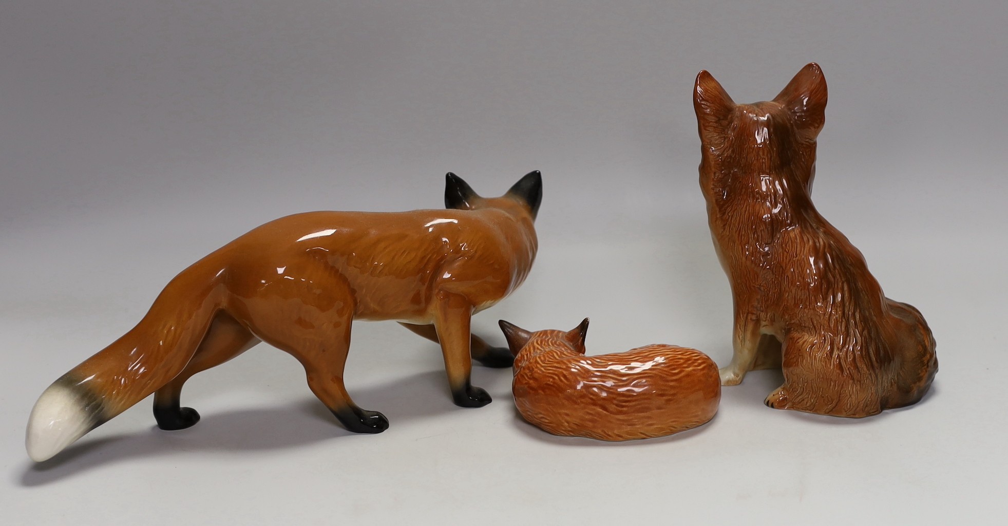 Two Beswick foxes and another